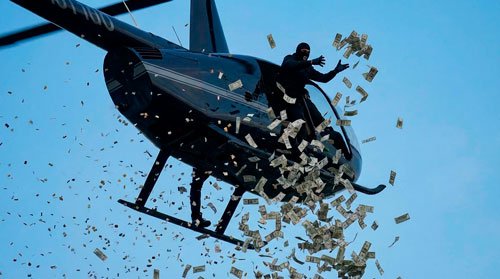 An unknown man was scattering money from a helicopter